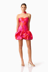 Brunette model wearing Eloise Strapless Mini Dress in Pink & Red posed shot