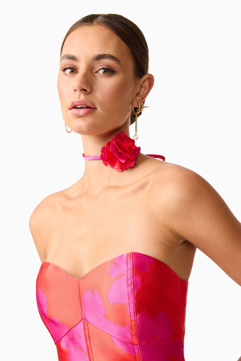 Brunette model wearing Eloise Strapless Mini Dress in Pink & Red detail shot