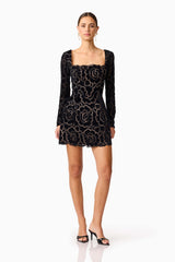 Brunette model wearing Eris Long Sleeve Mini Dress in Black posed shot 