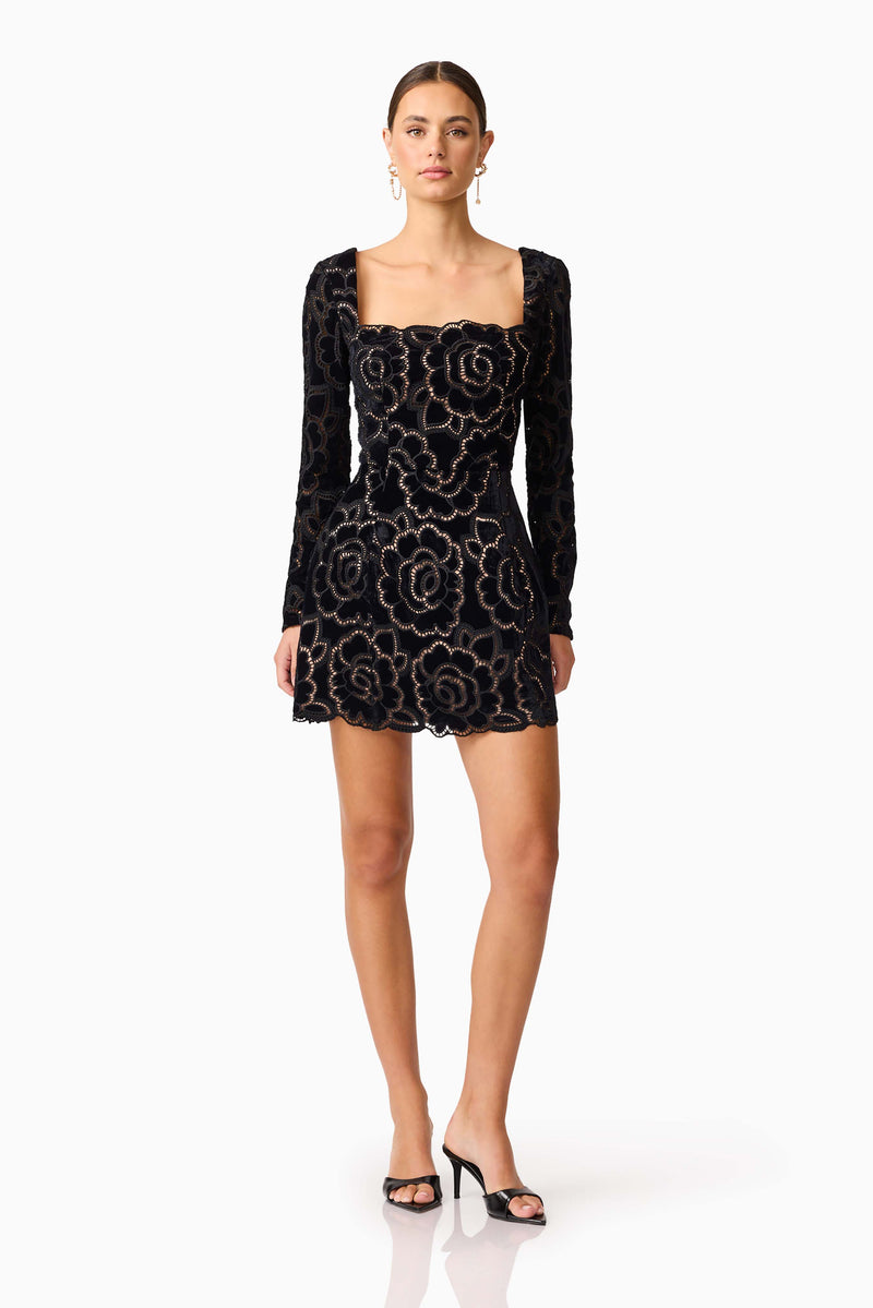 Brunette model wearing Eris Long Sleeve Mini Dress in Black posed shot 