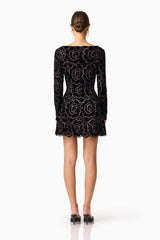 Brunette model wearing Eris Long Sleeve Mini Dress in Black back shot 