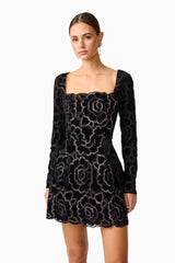 Brunette model wearing Eris Long Sleeve Mini Dress in Black close up shot 