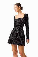 Brunette model wearing Eris Long Sleeve Mini Dress in Black close up looking away shot 