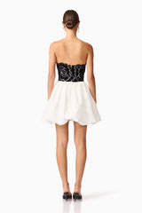 Brunette model wearing Eris Strapless Mini Dress in Black & White back shot
