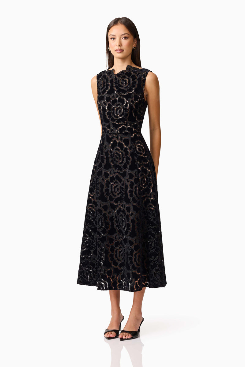 Brunette model wearing Eris Fit & Flare Midi Dress in Black side shot 