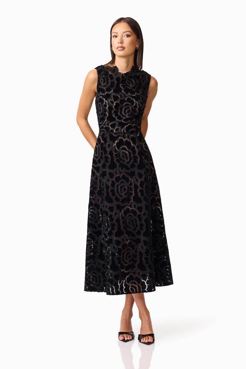 Brunette model wearing Eris Fit & Flare Midi Dress in Black posed shot 