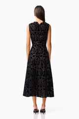 Brunette model wearing Eris Fit & Flare Midi Dress in Black back shot 