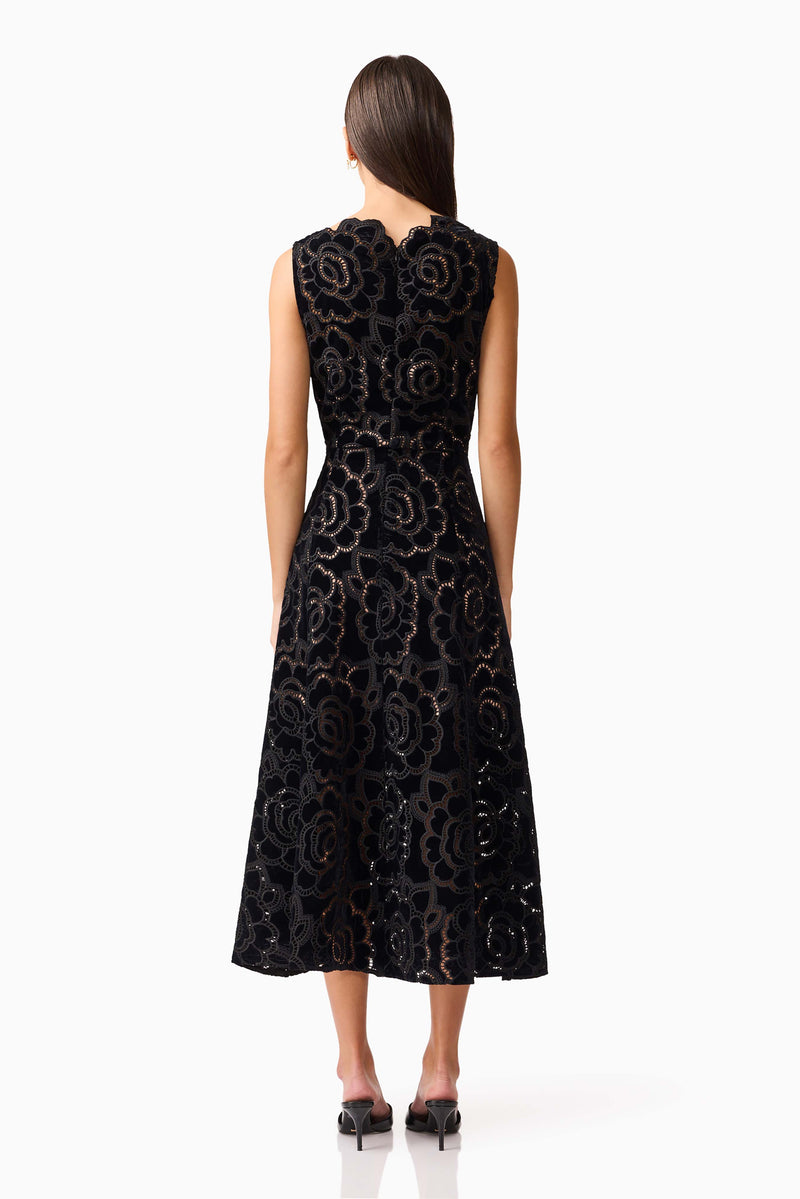 Brunette model wearing Eris Fit & Flare Midi Dress in Black back shot 