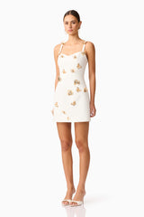 Brunette model wearing Mira Sweetheart Mini Dress in White side shot 
