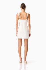 Brunette model wearing Mira Sweetheart Mini Dress in White back shot 