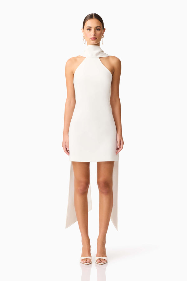 Brunette model wearing Mira Halter Mini Dress in White front shot 
