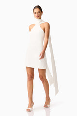 Brunette model wearing Mira Halter Mini Dress in White posed shot 