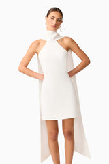 Brunette model wearing Mira Halter Mini Dress in White close up shot 
