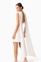 Brunette model wearing Mira Halter Mini Dress in White detail shot 