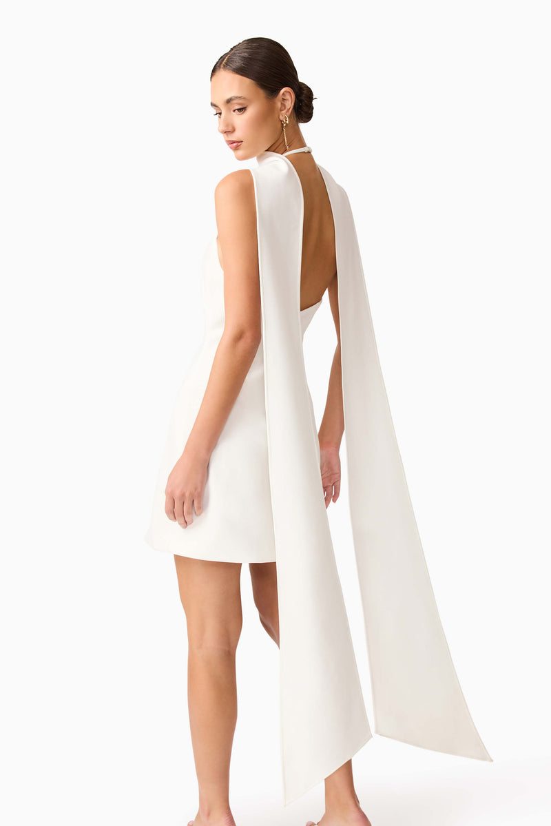 Brunette model wearing Mira Halter Mini Dress in White detail shot 