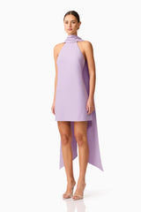 Brunette model wearing Mira Halter Mini Dress in Purple side shot 