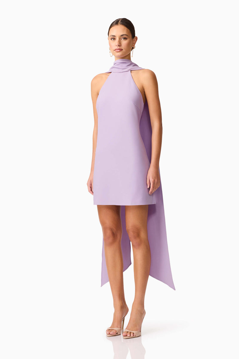 Brunette model wearing Mira Halter Mini Dress in Purple side shot 