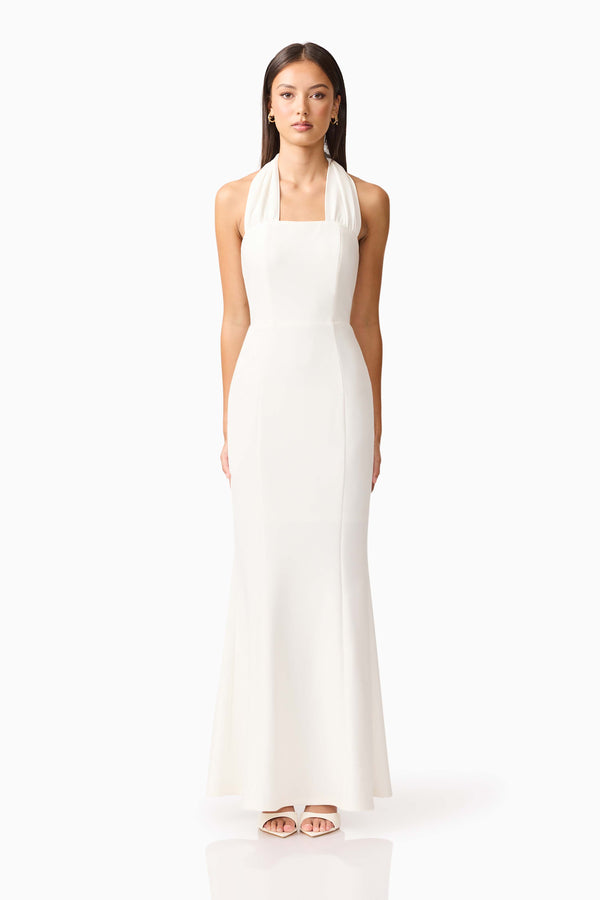 Brunette model wearing the Mira Halter Gown in White front shot 