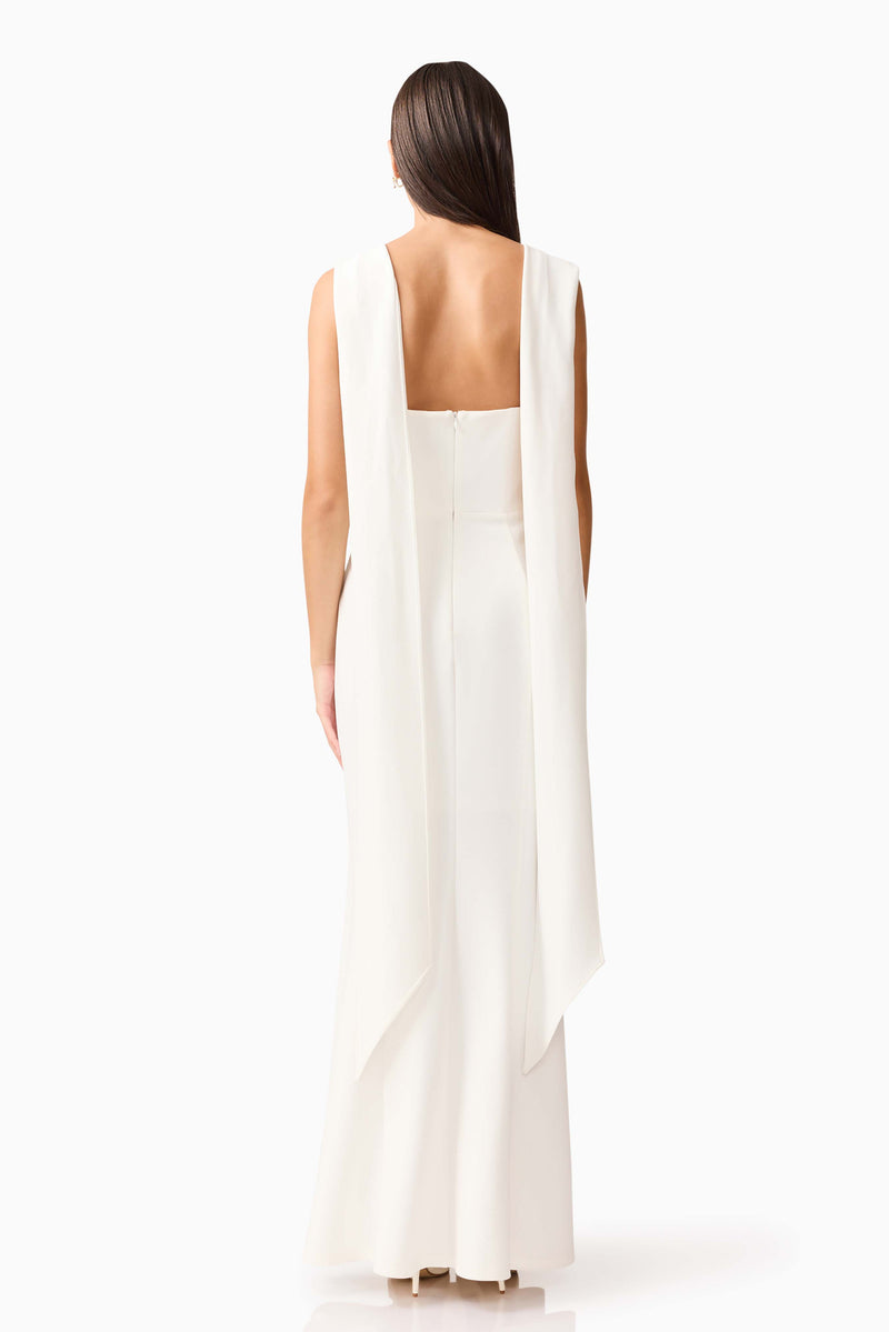 Brunette model wearing the Mira Halter Gown in White back shot 