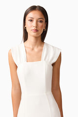 Brunette model wearing the Mira Halter Gown in White close up shot 