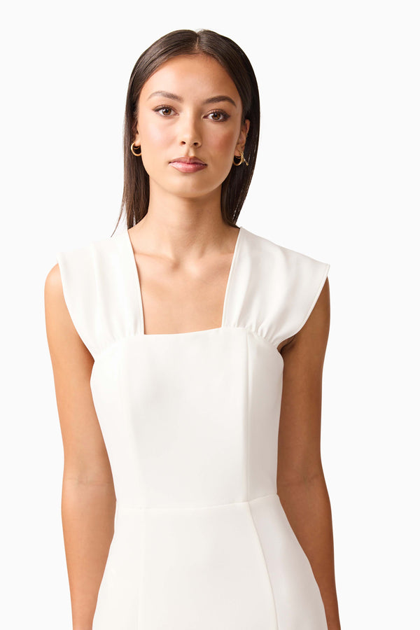 Brunette model wearing the Mira Halter Gown in White close up shot 