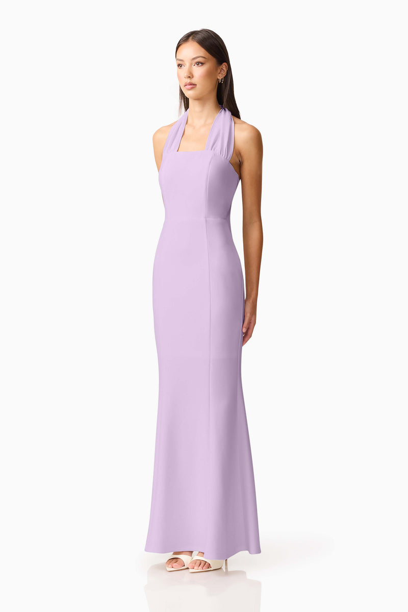 Brunette model wearing the Mira Halter Gown in Purple side shot 