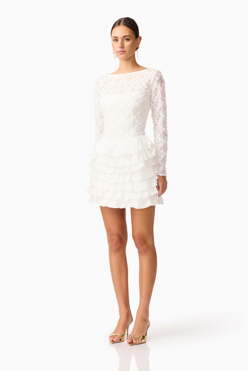 Brunette model wearing Athena Long Sleeve Lace Mini Dress in White side shot