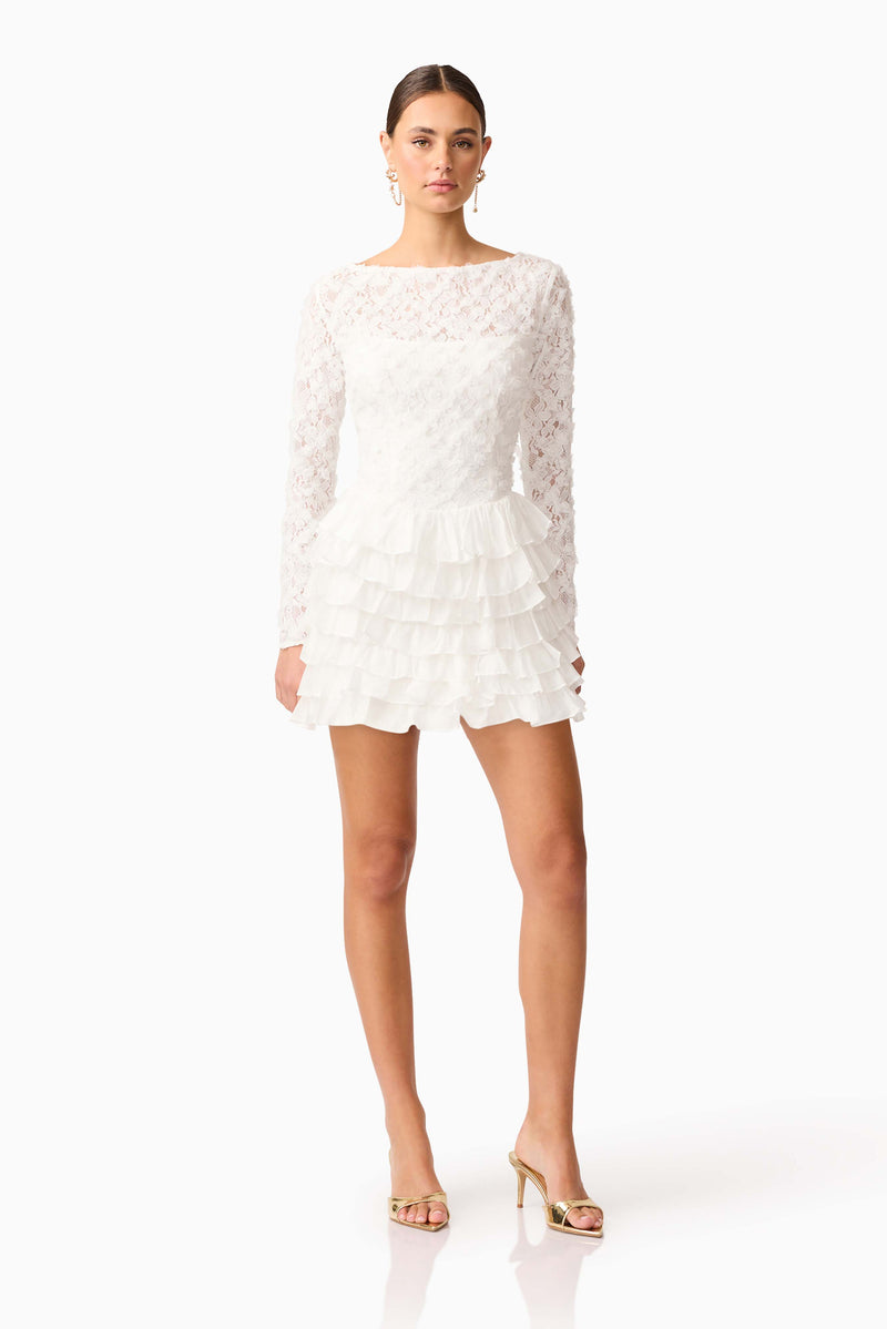 Brunette model wearing Athena Long Sleeve Lace Mini Dress in White posed shot