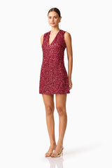 Brunette model wearing Carmen Shift Mini Dress in Red side shot