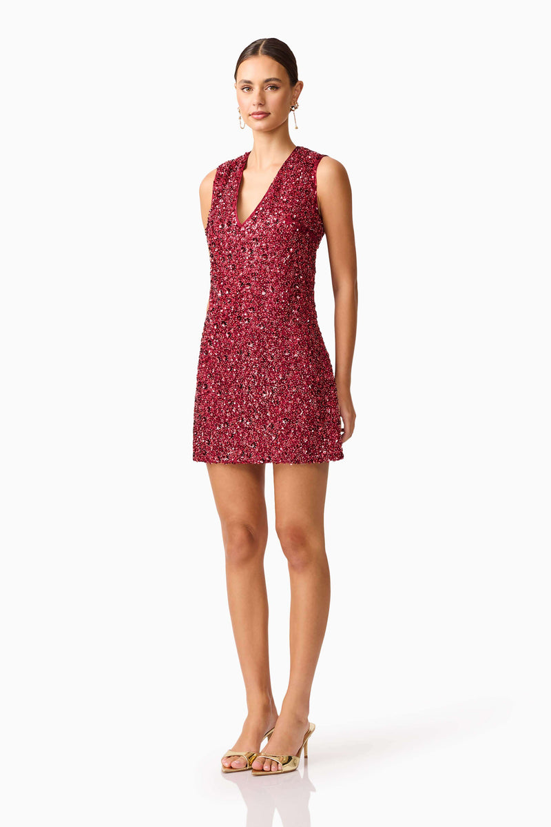 Brunette model wearing Carmen Shift Mini Dress in Red side shot