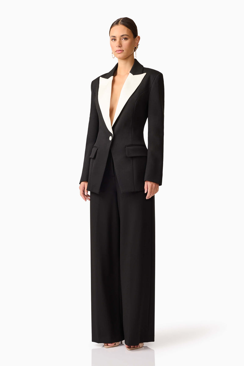 Brunette model wearing the Leonie Wide Leg Pants In Black side shot