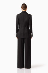 Brunette model wearing the Leonie Wide Leg Pants In Black back shot