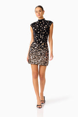 Primelle Embellished Mini Dress in Black & Gold with embellished velvet fabrication & cap sleeves walking shot