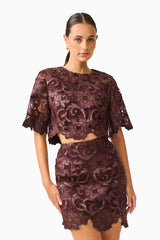 Novelle Top & Mini Skirt Set in Chocolate Brown with round neckline & scalloped hem close up posed shot