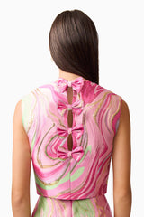 Brunette model wearing Mirella Top & Skirt Set in Pink back detail shot