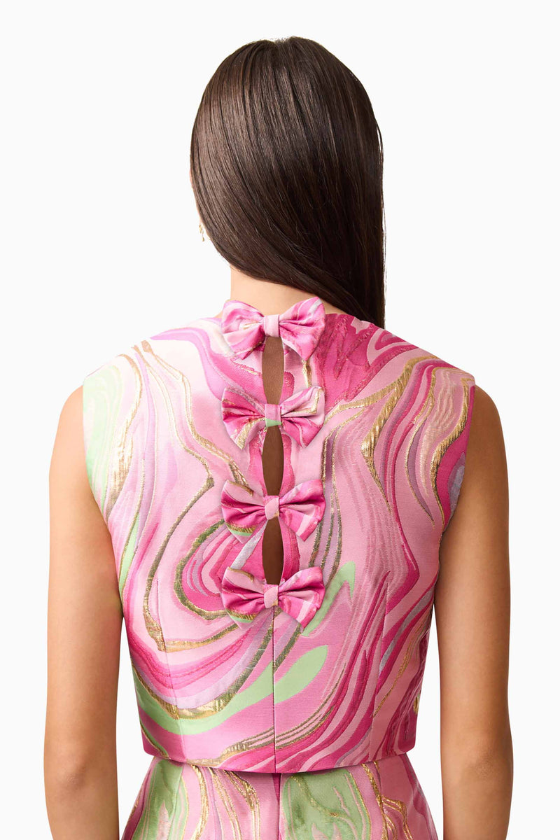Brunette model wearing Mirella Top & Skirt Set in Pink back detail shot