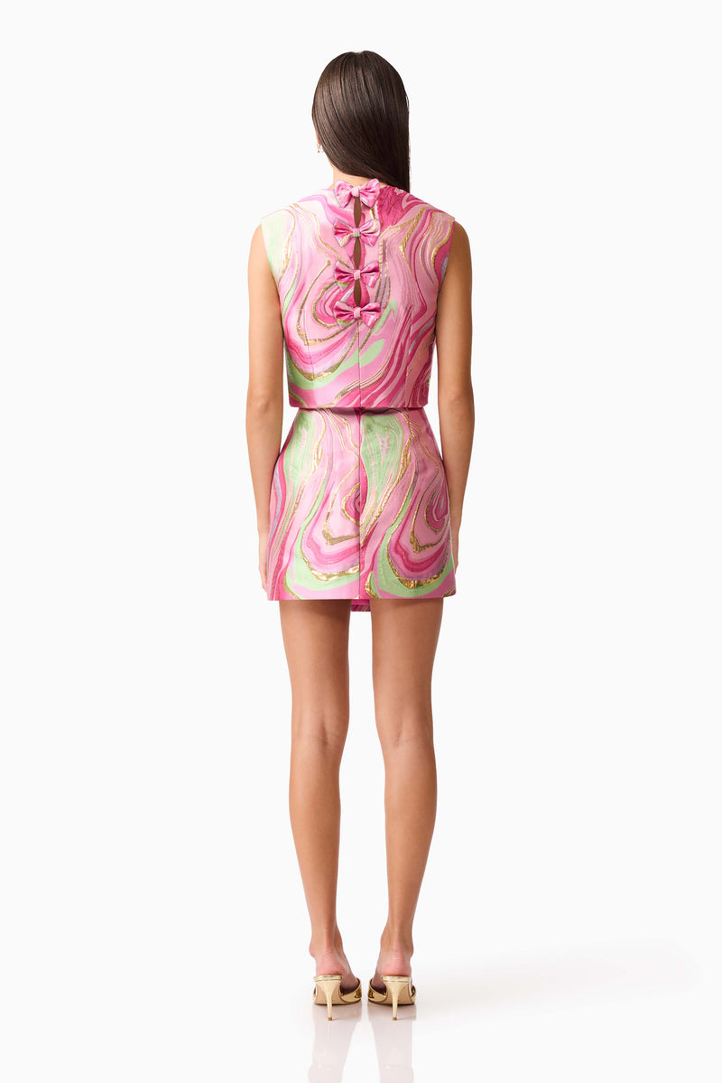 Brunette model wearing Mirella Top & Skirt Set in Pink back shot