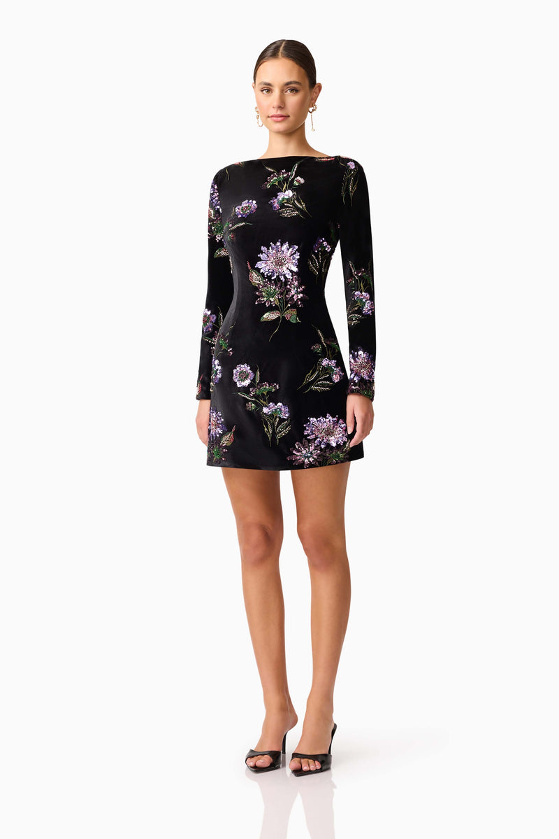 Brunette model wearing the Clio Long Sleeve Mini Dress in Black side shot