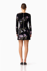 Brunette model wearing the Clio Long Sleeve Mini Dress in Black back shot