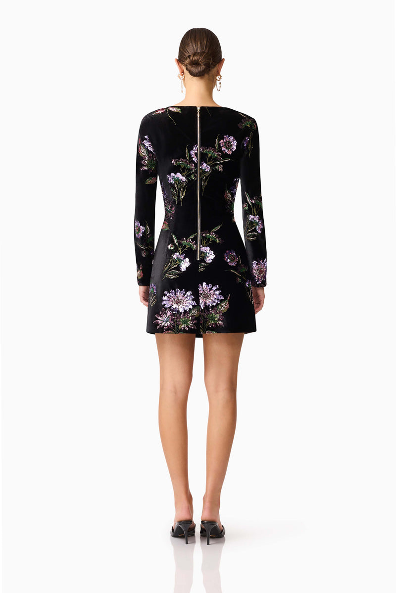 Brunette model wearing the Clio Long Sleeve Mini Dress in Black back shot