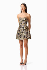Brunette model wearing the Celeste Strapless Mini Dress in Black and Gold side shot