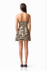 Brunette model wearing the Celeste Strapless Mini Dress in Black and Gold back shot