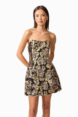 Brunette model wearing the Celeste Strapless Mini Dress in Black and Gold close up shot