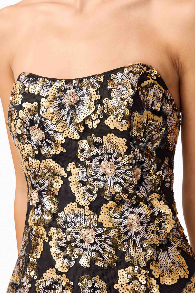 Brunette model wearing the Celeste Strapless Mini Dress in Black and Gold detail shot