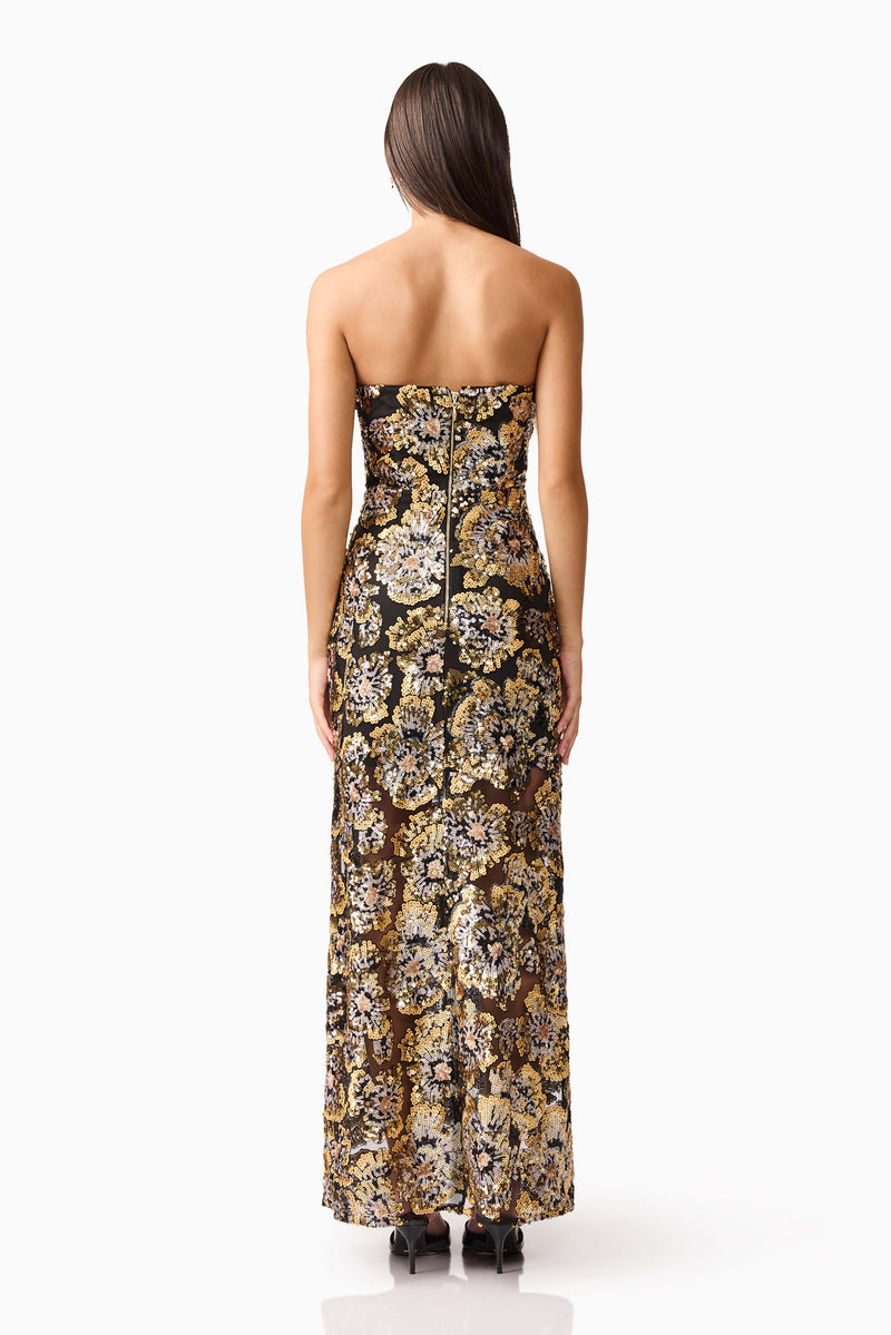 Brunette model wearing the Celeste Strapless Gown in Black and Gold back shot