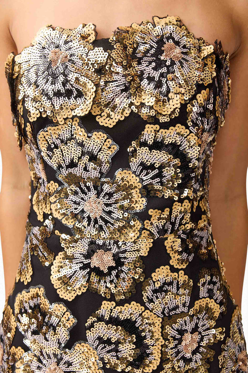 Brunette model wearing the Celeste Strapless Gown in Black and Gold detail shot