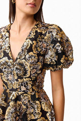 Brunette model wearing the Celeste Puff Sleeve Mini Dress in Black and Gold detail shot