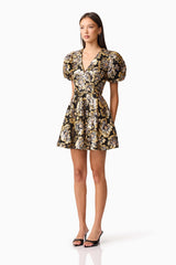 Brunette model wearing the Celeste Puff Sleeve Mini Dress in Black and Gold side shot