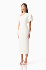Brunette model wearing the Hester Puff Sleeve Midi Dress in White side shot