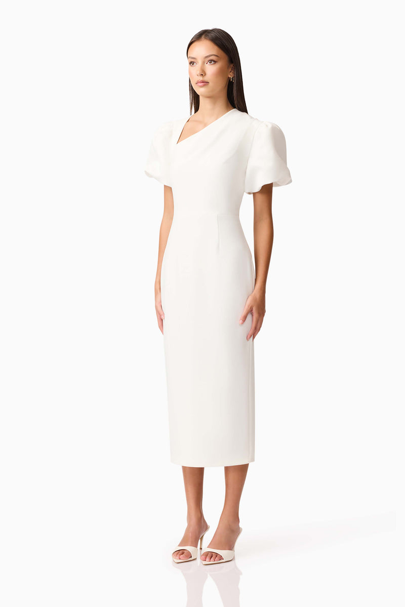 Brunette model wearing the Hester Puff Sleeve Midi Dress in White side shot